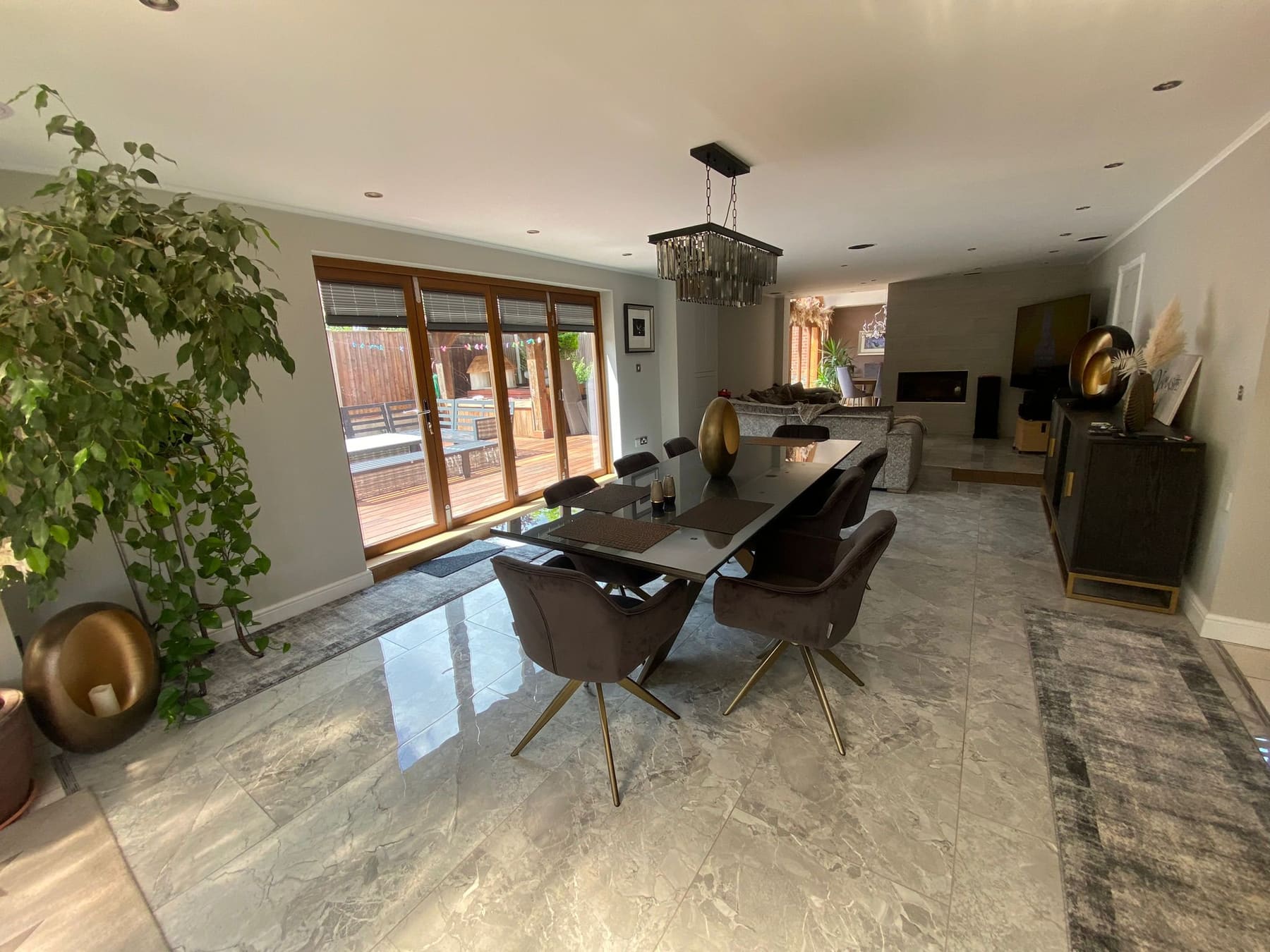 Open-plan dining area with polished floor and timber bi-fold doors