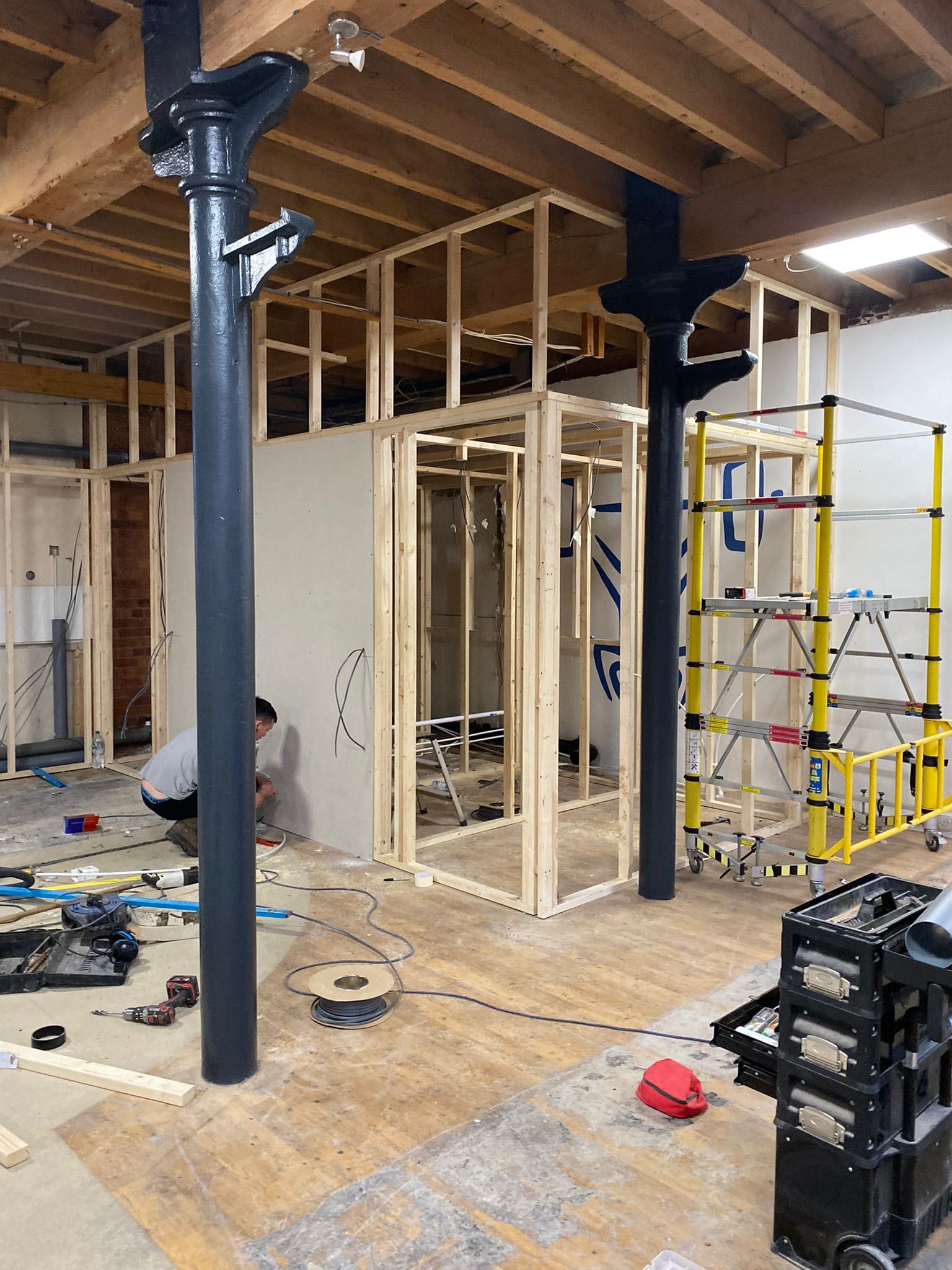 Timber stud partitions framed around cast iron columns