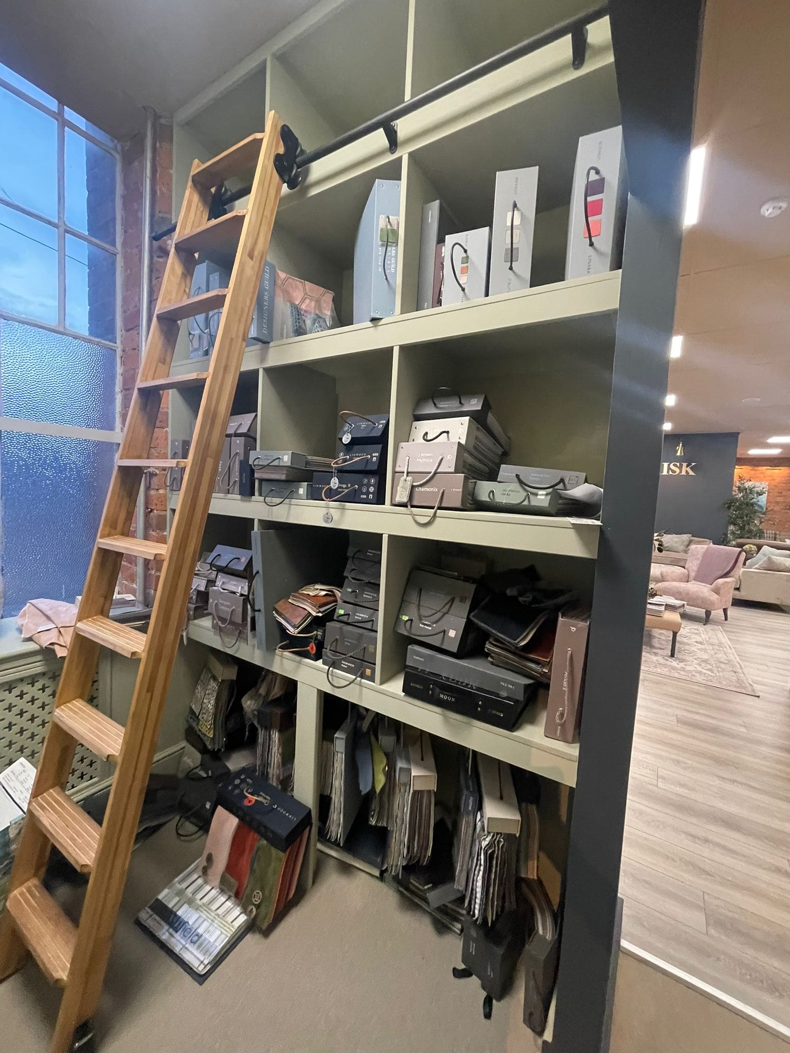 Display shelving with a sliding library ladder
